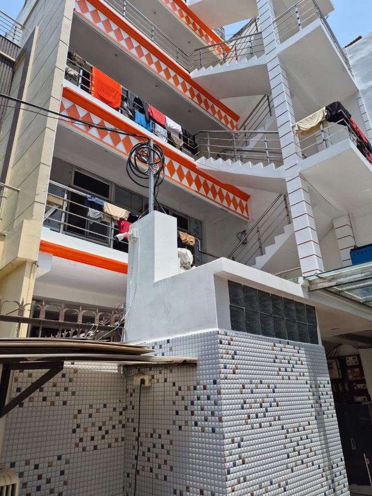 Kumar Hostel multi-storey building with balconies and security